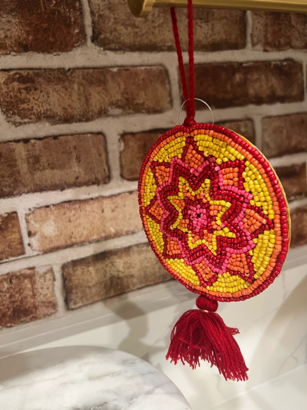 Cost Plus World Market Beaded Sunburst Wall Hanging in Red, Yellow, Orange